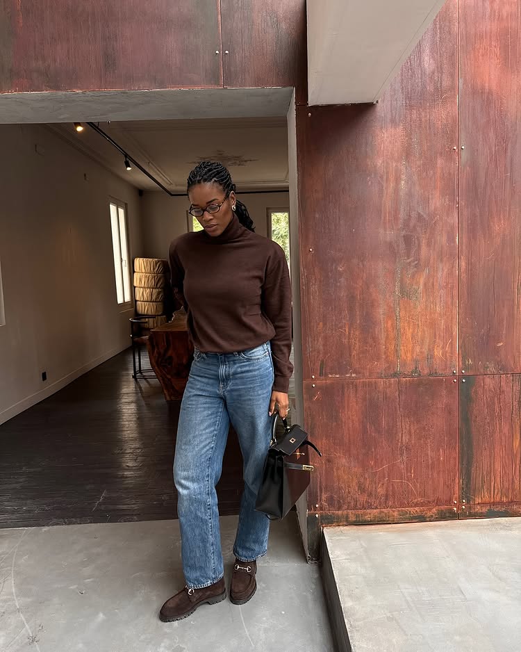 Classic Pieces 2025: @nlmarilyn wears a pair of brown suede loafers with blue jeans and a brown roll neck jumper