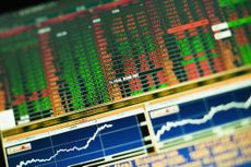 closeup of ticker board on computer monitor with stock charts below