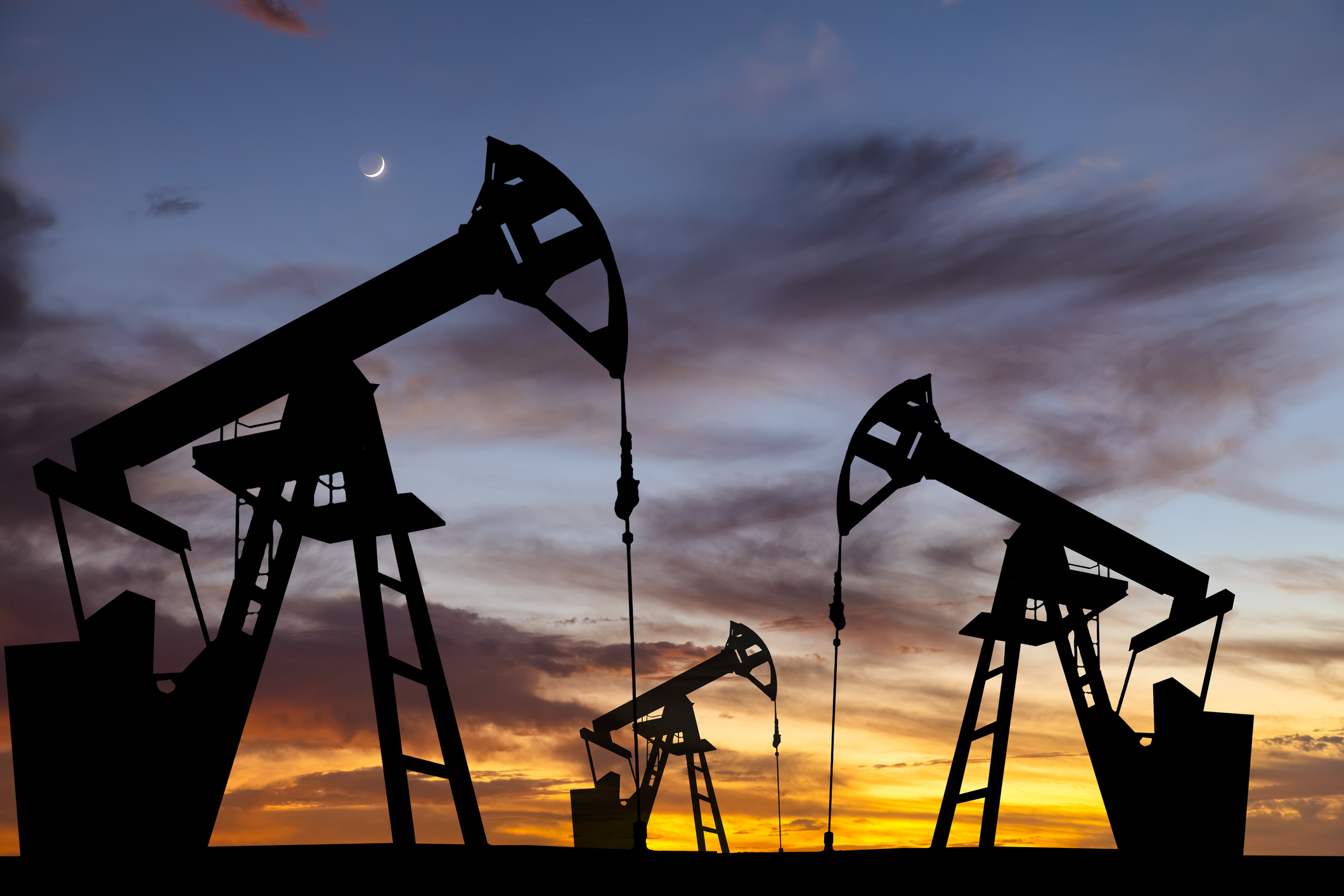 oil pumps with a sunset in the background