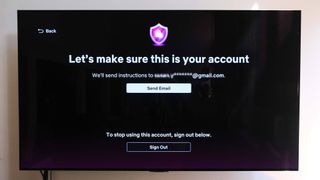 A TV with the message "Let's make sure this is your account" that offers to send a confirmation email" — a part of the Netflix password-sharing crackdown