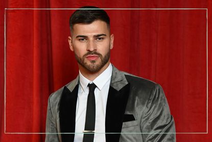 A photo of Owen Warner in front of a red curtain at an awards ceremony