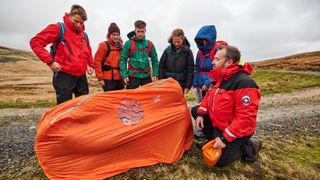 Mountain Rescue demonstrating how to use a bothy bag