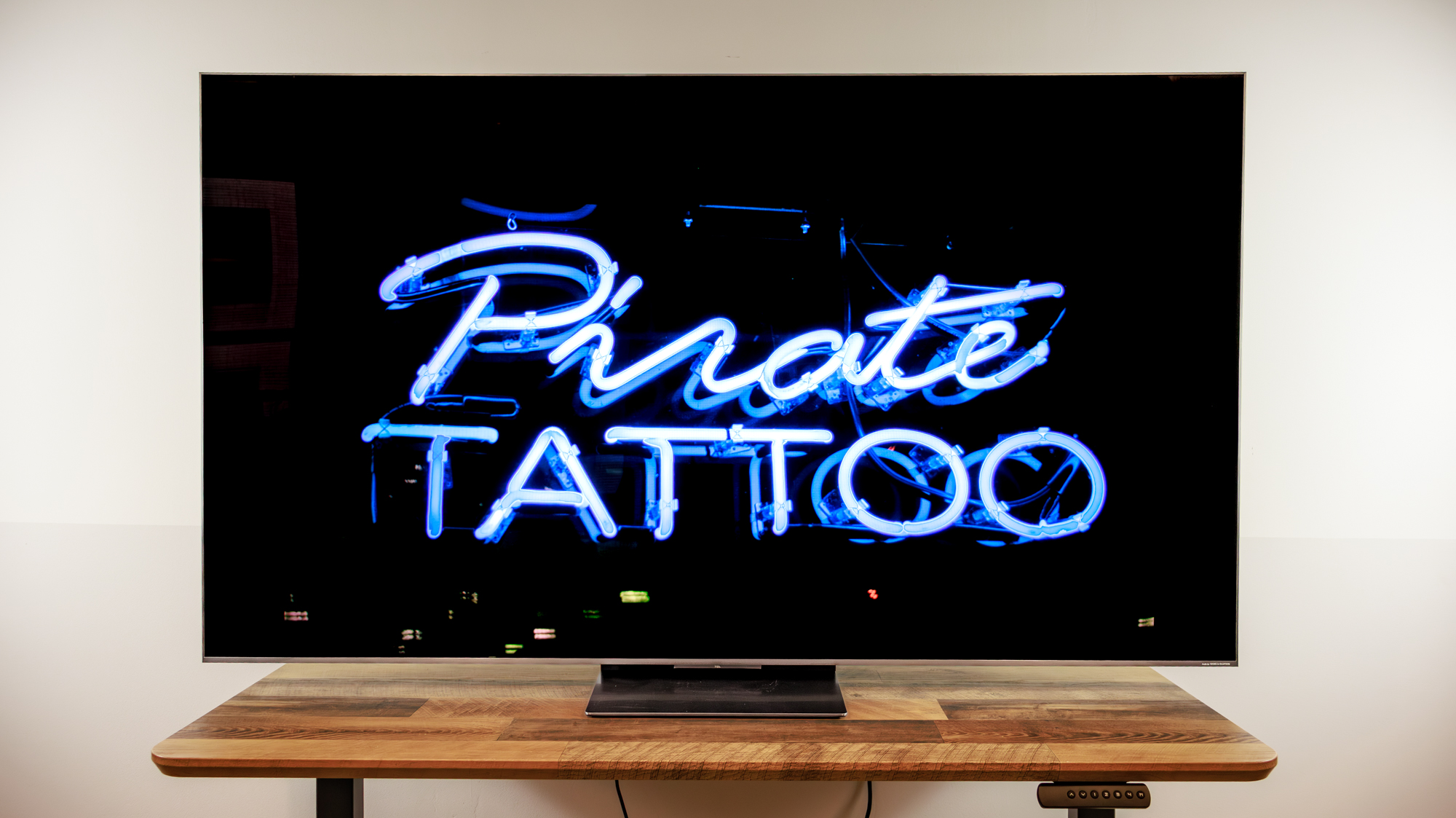 A TCL QM8L TV on a desk