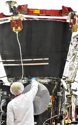 The red wheel on the top of the spacecraft, dubbed the wagon wheel, simulates the mass of the heat shield during testing.