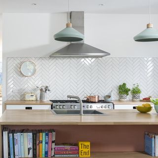 white kitchen with worktop and hanging lights