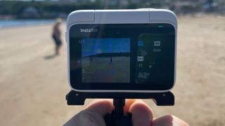 Insta360 GO 3 action camera on a beach