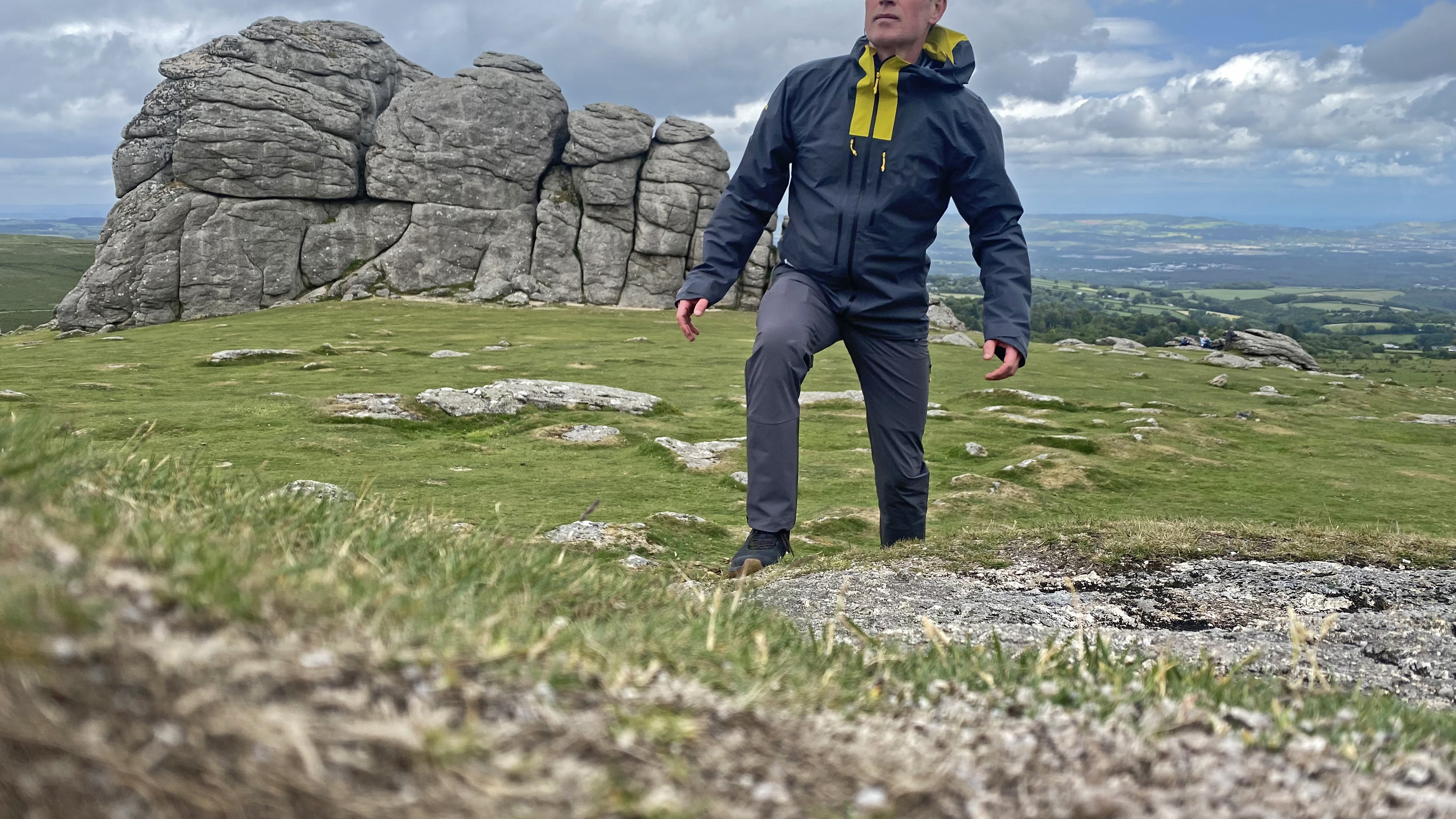 Hill walker wearing the Haglöfs LIM Flex pants on Dartmoor, with Haytor in the background