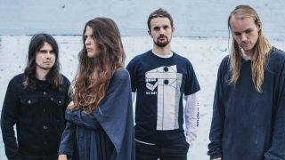 Oathbreaker standing against a grey wall