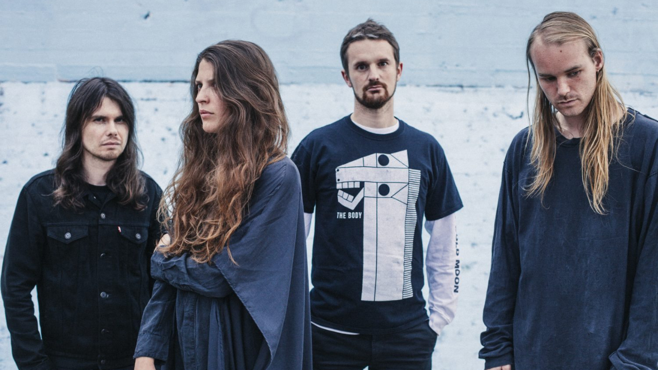 Oathbreaker standing against a grey wall