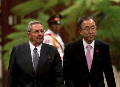 Cuban leader Raul Castro walks with U.N. Secretary General Ban Ki-Moon