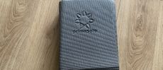 Primasole folding yoga mat on wooden floor