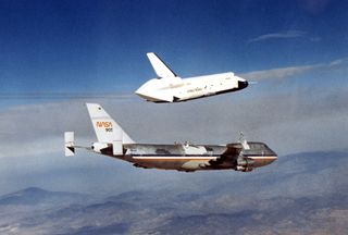 The Space Shuttle prototype Enterprise flies free of NASA's 747 Shuttle Carrier Aircraft (SCA) during one of five free flights carried out at the Dryden Flight Research Facility, Edwards, California in 1977 as part of the Shuttle program's Approach and Landing Tests (ALT).