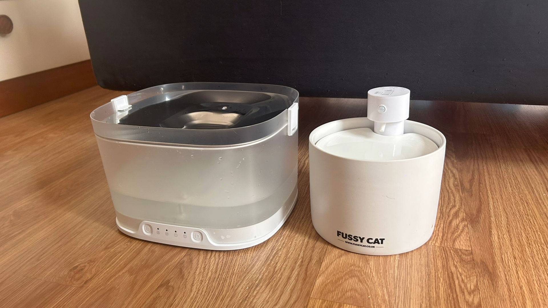 Fussy Cat Fountain and Cheerble Fountain next to each other on wooden flooring