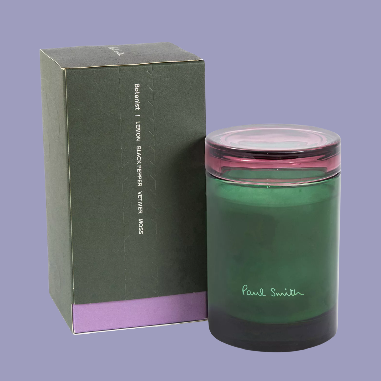 A green glass candle with a purple lid
