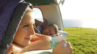 Couple waking up in camper