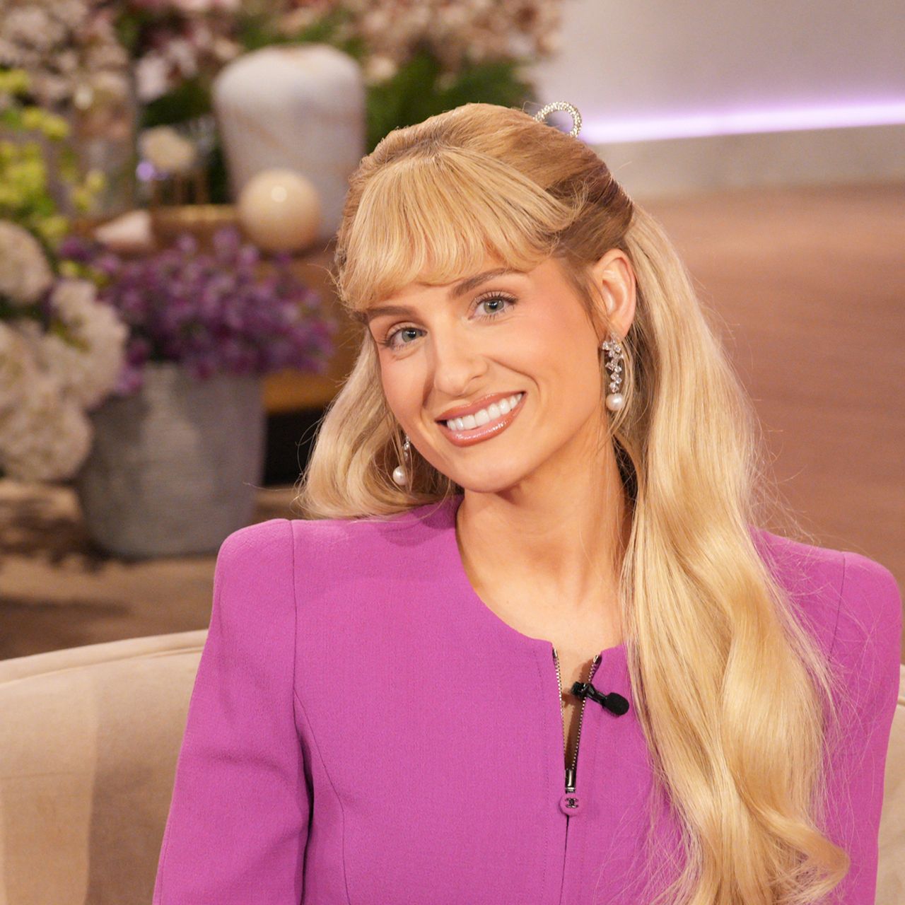 Meghan Trainor wearing cerise in front of flowers