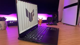 Asus TUF A14 gaming laptop on wooden desk