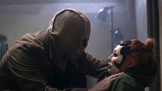 Scarecrow is shown putting a mask on Maya in The Strangers: Chapter 3.