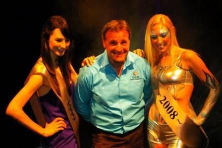 Race director Mike Turtur poses for photos with two of the podium girls.
