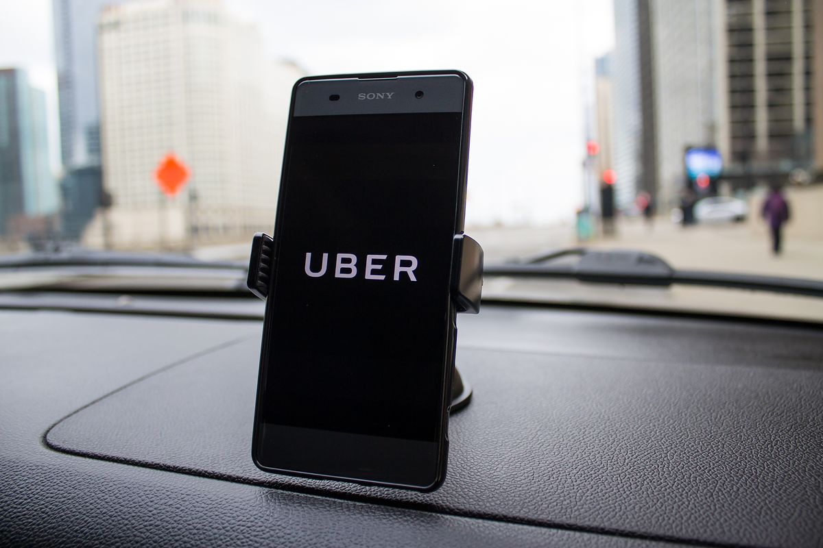 Uber app displayed on a car dashboard