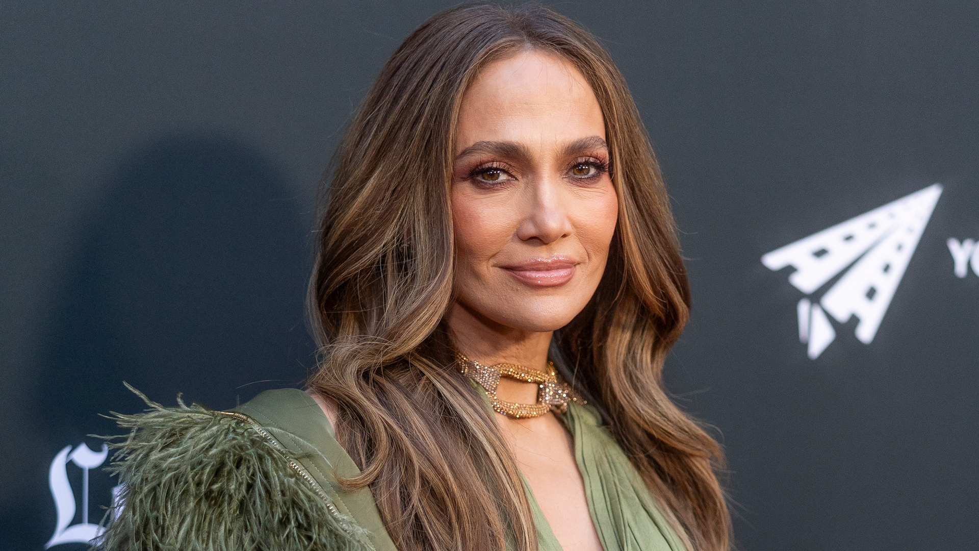 Jennifer Lopez traded wide-leg work trousers for a green cut-out-heavy dress