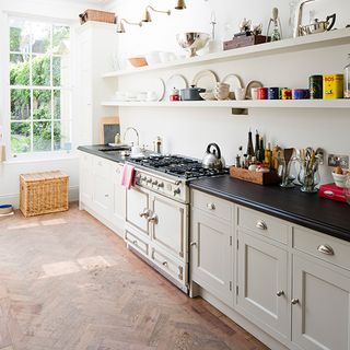 kitchen room with open shelve crockery and black worktop