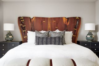 A bedroom with light gray walls and pure white bedding