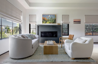 grey living room with white armchairs and Samsung Frame TV on the wall