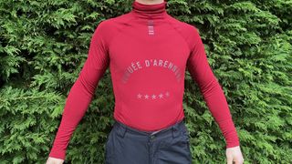 Man in long-sleeved base layer by hedge