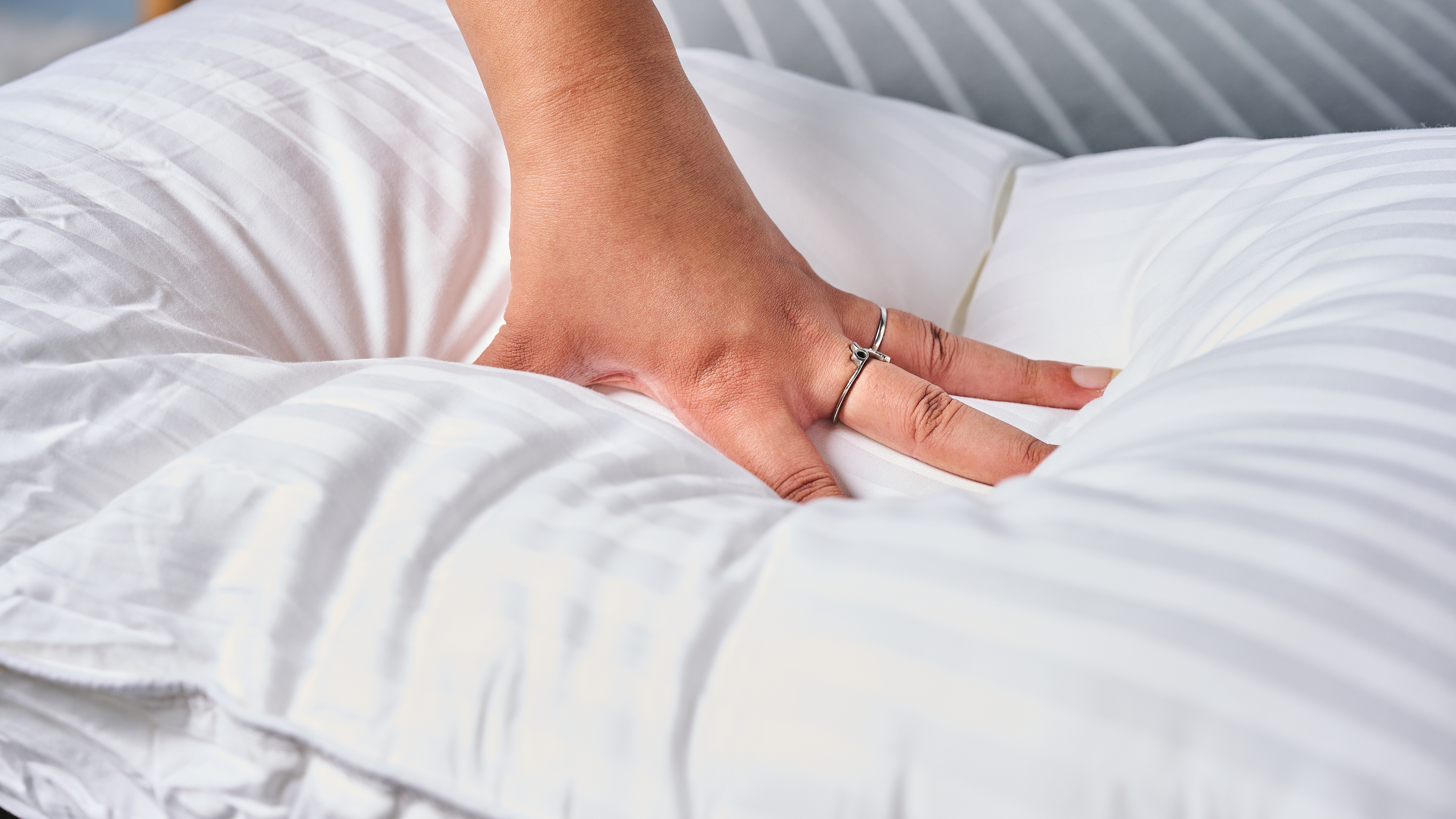 Hand pressed into the Beckham Hotel Collection Down-Alternative pillow to gauge the depth or plushness