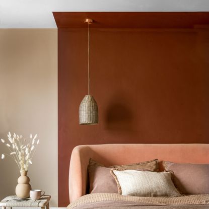 terracotta painted wall effect in bedroom with hanging pendant light