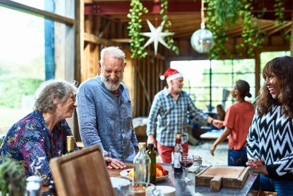 People laughing over table at Christmas party