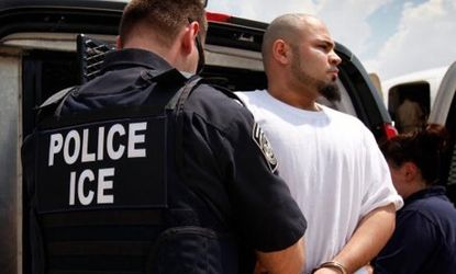 An undocumented immigrant is moved from a van to a jet chartered by U.S. Immigration and Customs Enforcement (ICE).