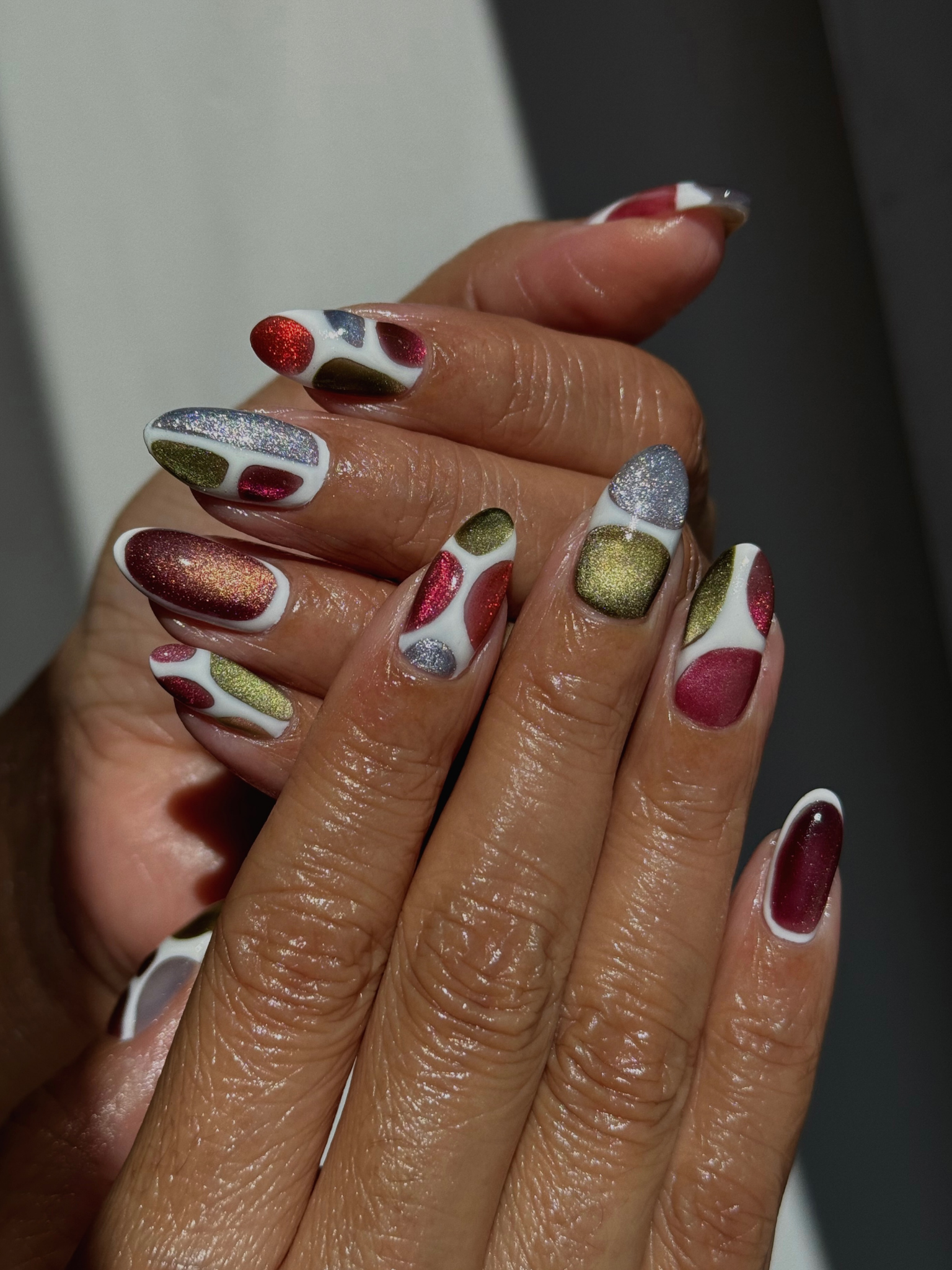 Nails painted in an assortment of jewel tone shades