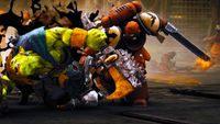 A green-skinned fighter in clashes with an orange-armored warrior wielding a chainsword in a grim, explosive sci-fi battle.