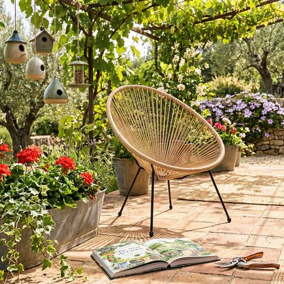 Belavi patio chair from Aldi on a garden patio.
