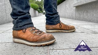 Man wearing the Helly Hansen Coastal Hiker walking boots on a city sidewalk