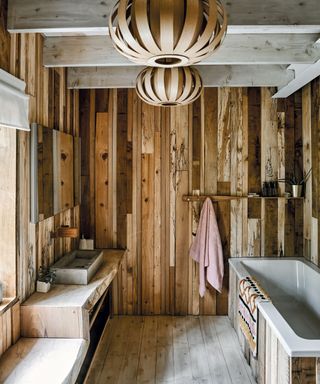 Rustic bathroom in lighting designer Tom Raffield's Cornish timber home