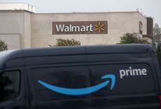 An Amazon Prime van parked in front of a Walmart store