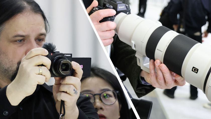 Person holding the Canon PowerShot V1 alongside another holding a Sony 400-800mm lens