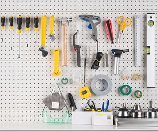 Hand Tools Hanging on Pegboard with Space