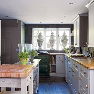 kitchen with three statuesque and cabinet and wooden top