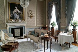 living room from Bridgerton featuring period furniture and pale blue soft furnishings