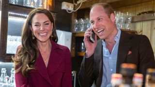 Prince William, Prince of Wales takes a restaurant booking beside Catherine, Princess of Wales