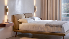 white bedroom with all white bedding, and floating nightstand