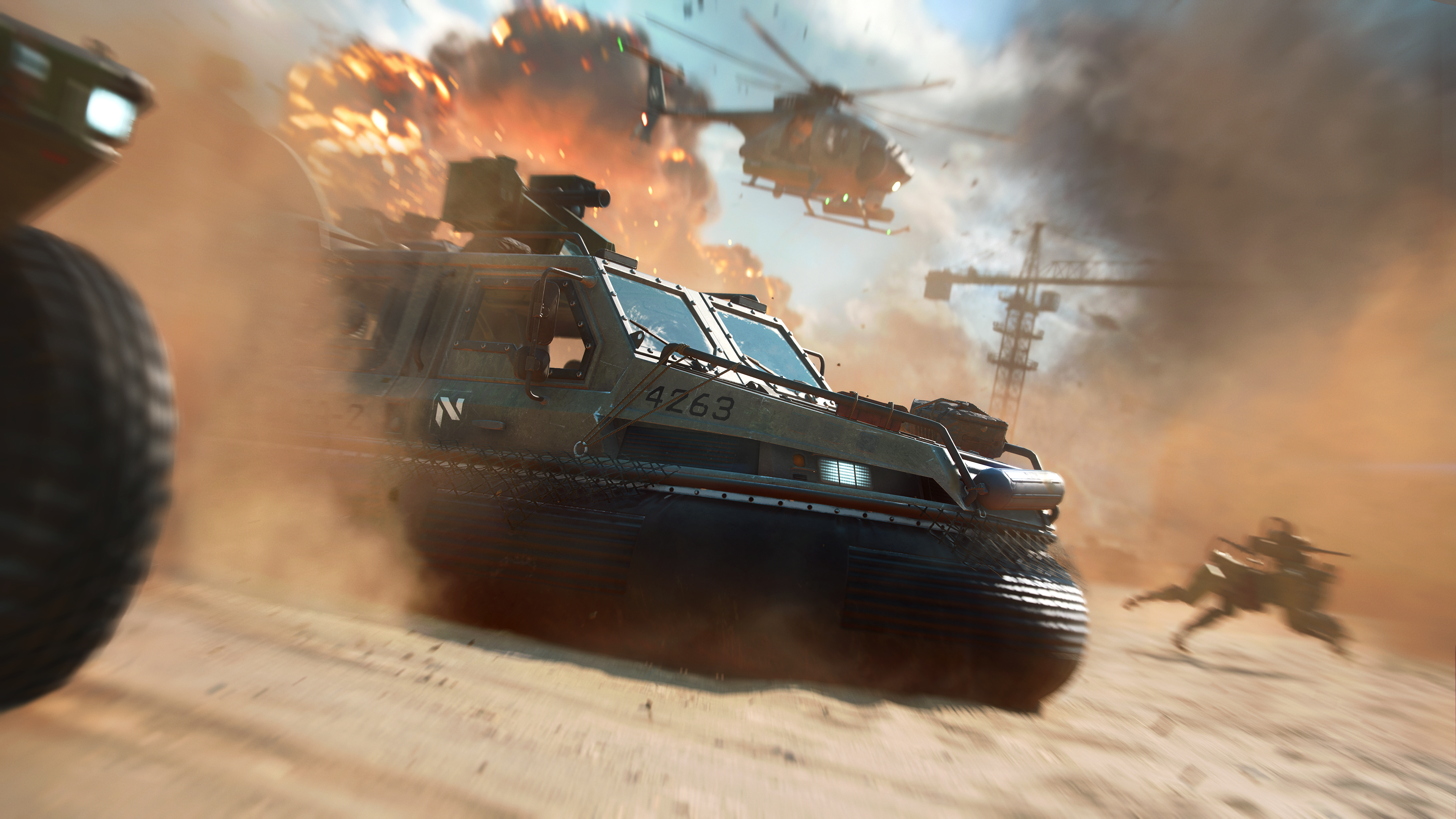 Battlefield 2042 a desert scene with moving vehicles and background explosions