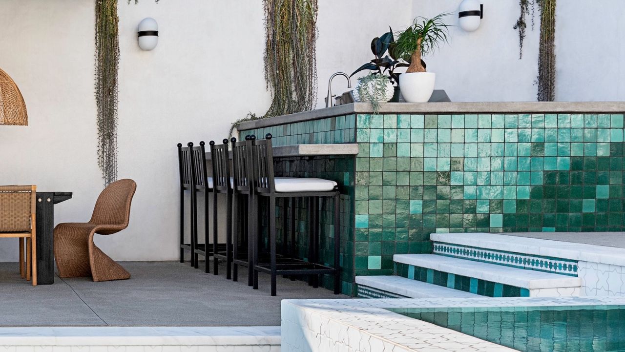 Outdoor bar stools around a backyard bar