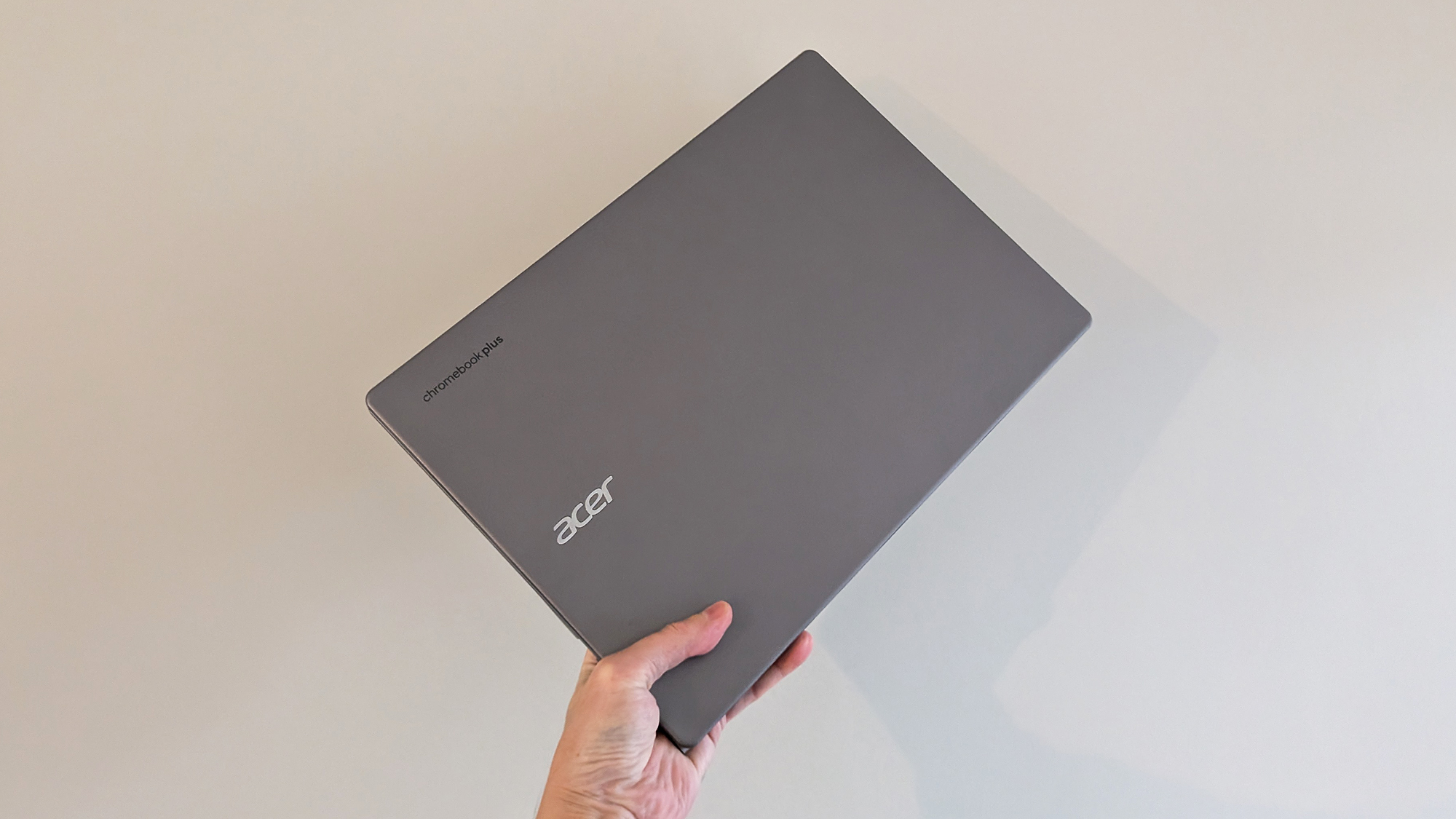 Acer Chromebook Plus 516 closed, being held