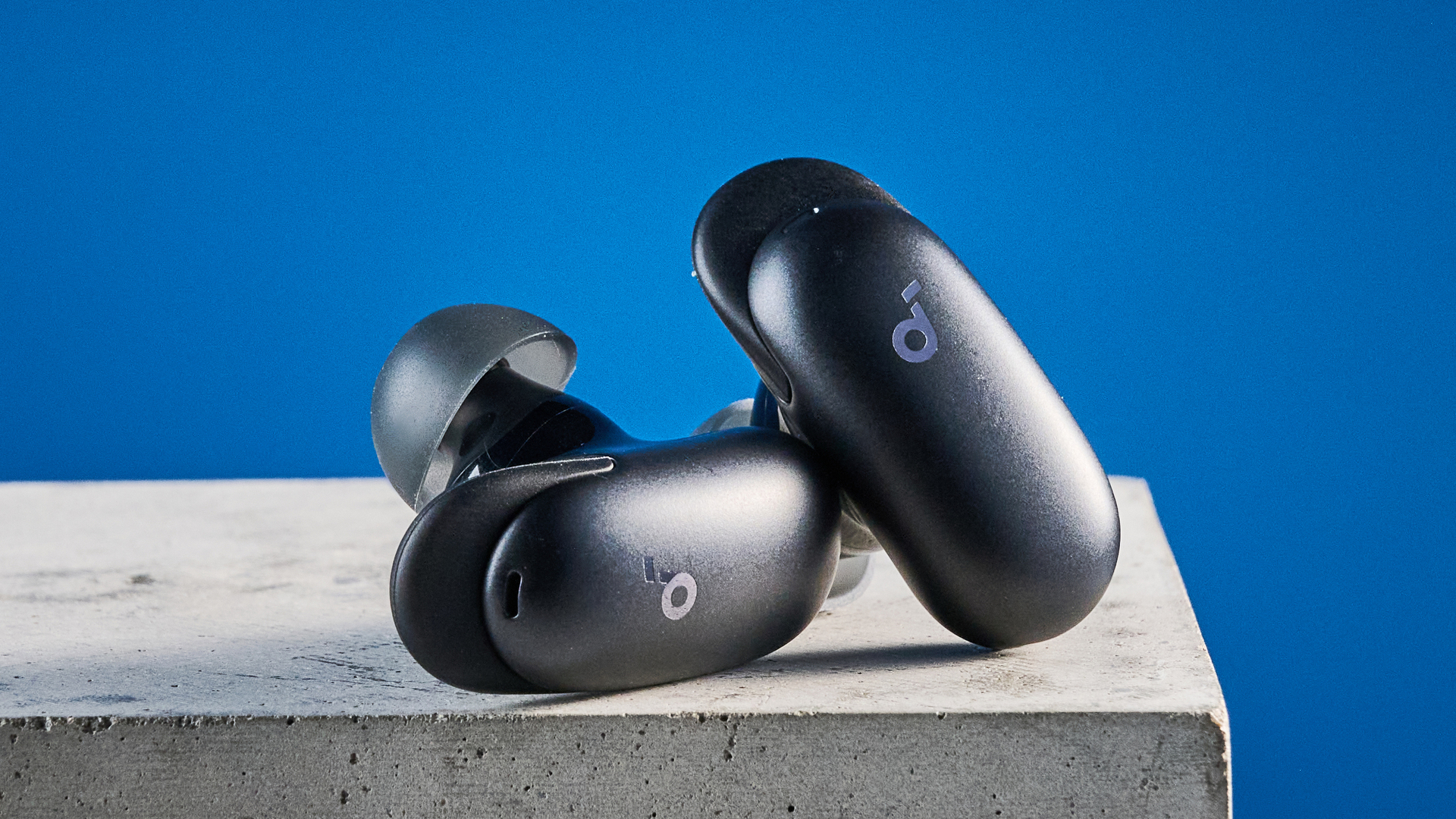 the soundcore liberty 5 pro max earbuds photographed against a blue tom's guide background