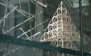 Stick model of a pyramid in a glass case